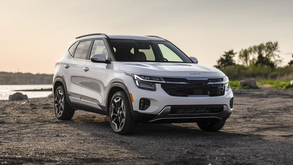 A white 2026 Kia Seltos SUV parked on a riverbank