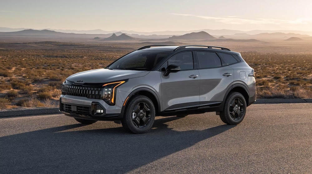 A gray 2026 Kia Sportage SUV on a desert road