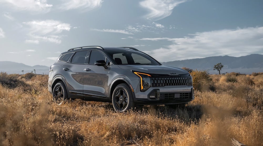 A gray 2026 Kia Sportage SUV in the desert